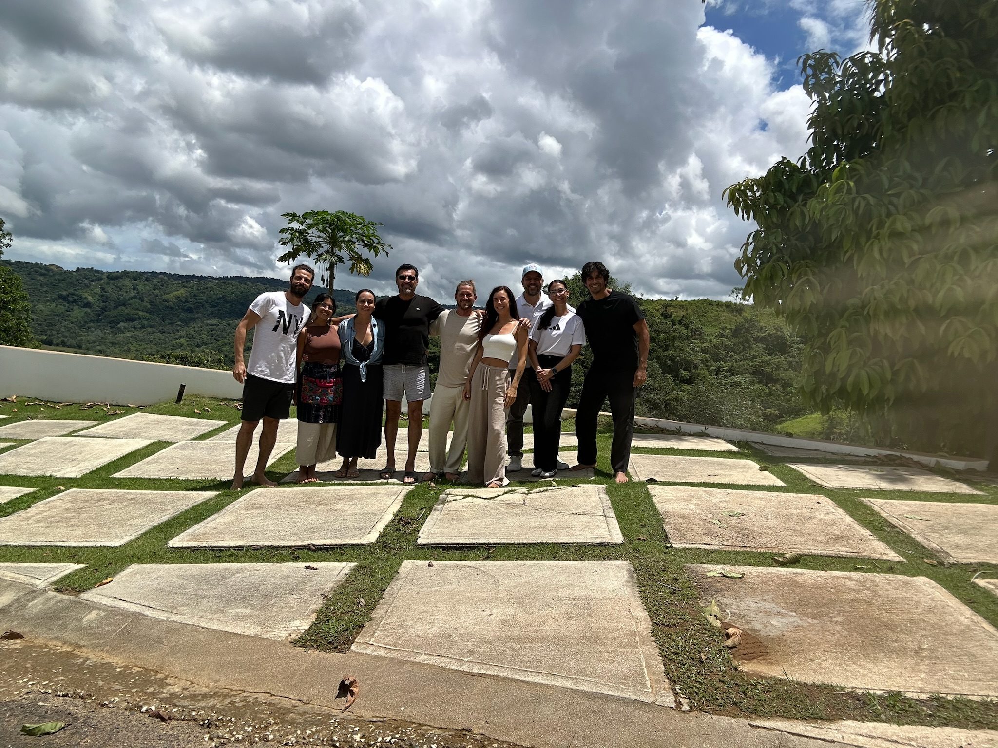 A gathering on a hilltop under wide clouds